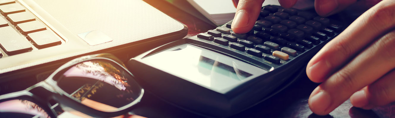 Close up of hands using a calculator