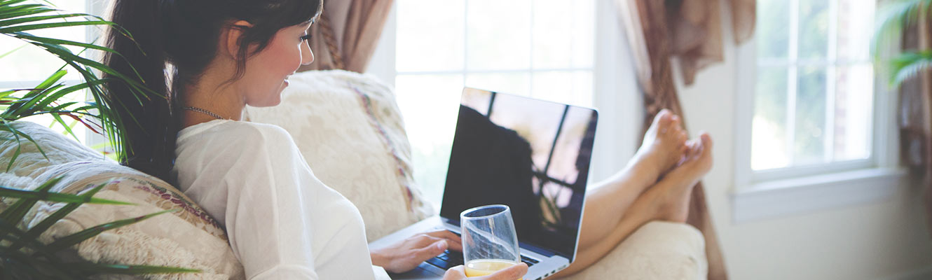 Woman using computer in living room