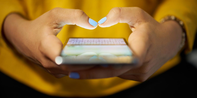 Close up of hands using phone