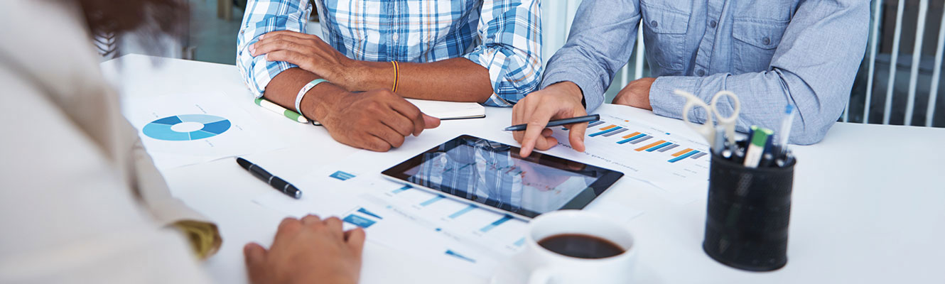 Business people reviewing work on tablet