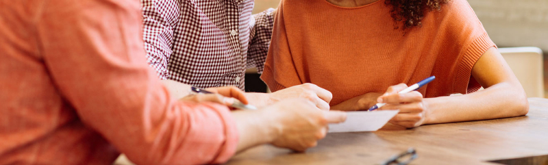 Loan officer discussing paperwork with clients