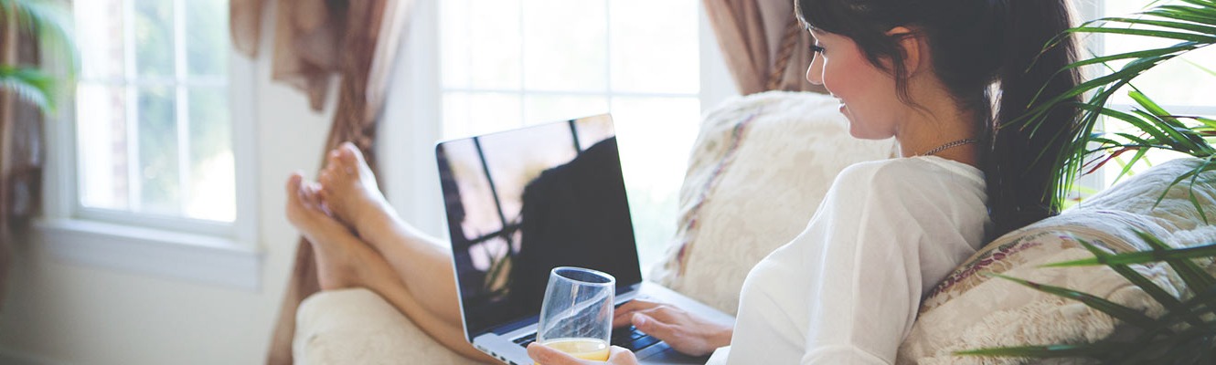 Woman using computer in living room