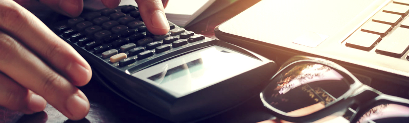 Close up of hands using a calculator