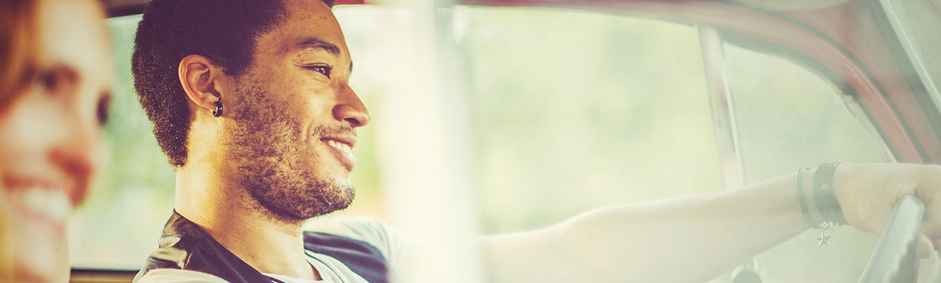 Young couple driving in car