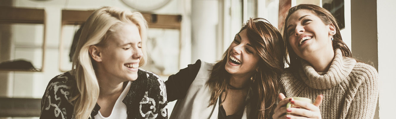 Three friends talking and laughing