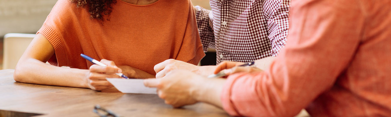 Loan officer discussing paperwork with clients